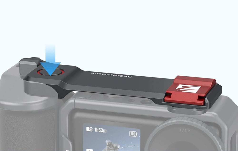 Close-up of the top panel of the camera cage with a red shutter button and engraving For Osmo Action 6