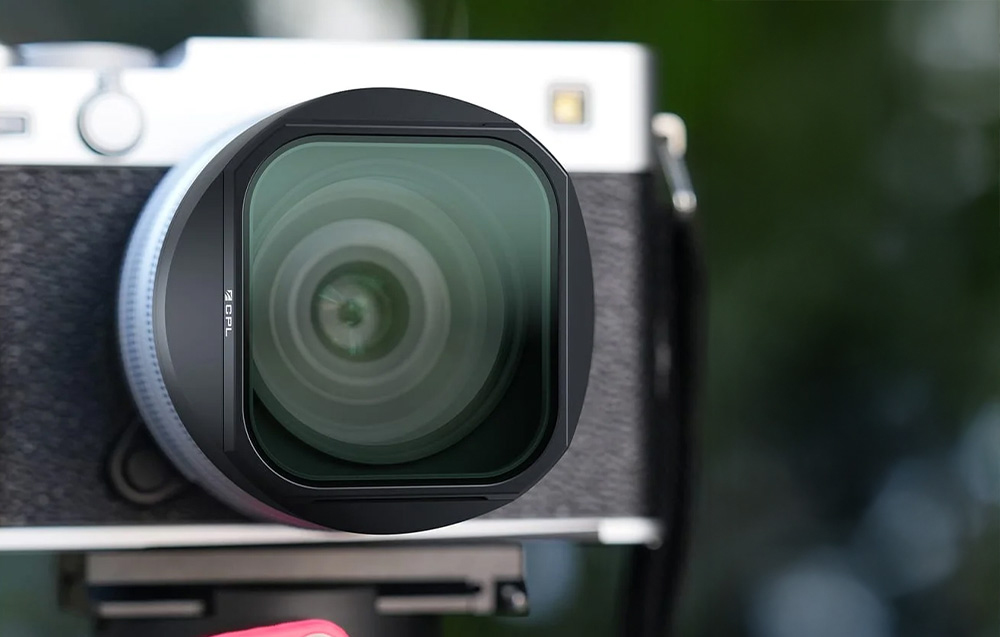 Close-up of a CPL polarizing filter mounted on a Fujifilm X100 series camera lens