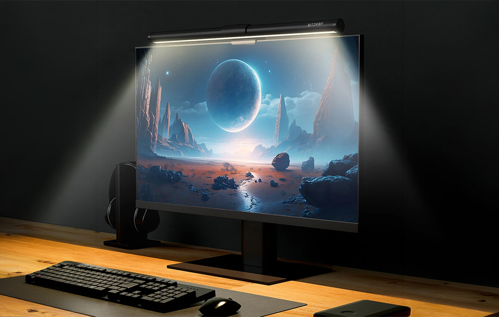 Desk with computer and lamp attached to the monitor