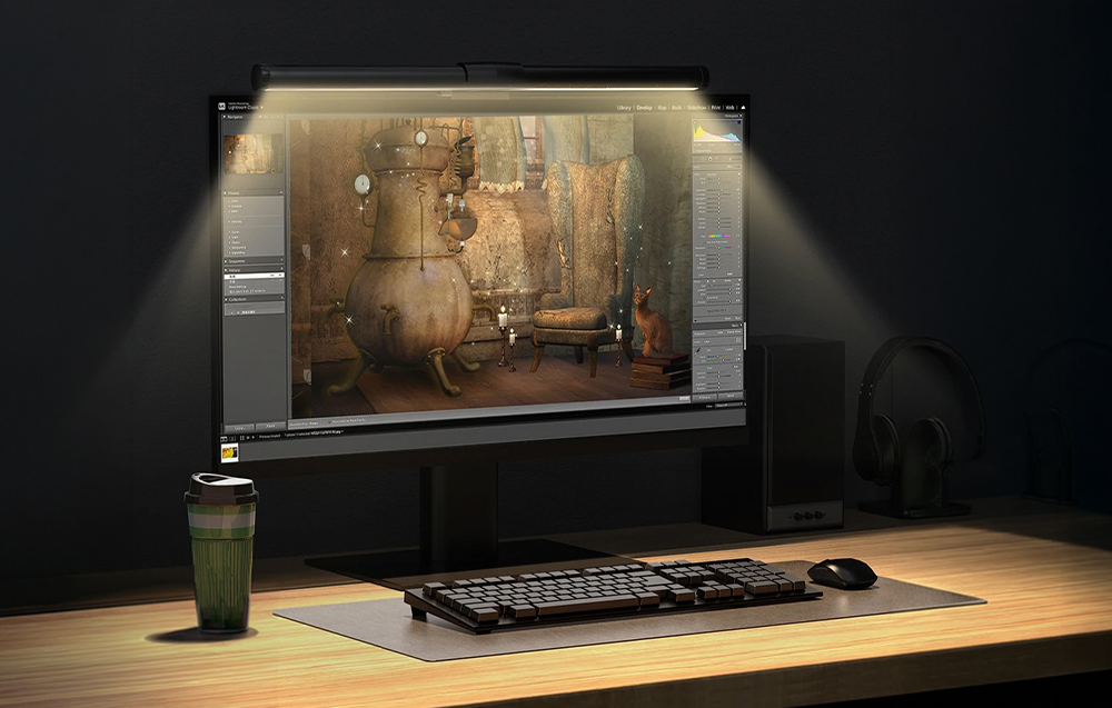 Monitor with lamp on desk displaying photo editing software