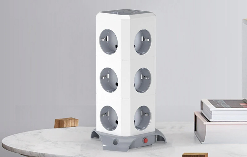 Blitzwolf power strip on a table next to books