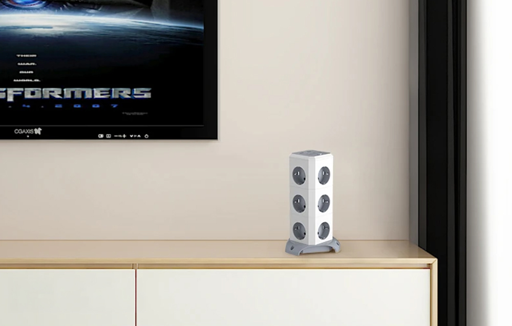 Power strip lying on a dresser under a television