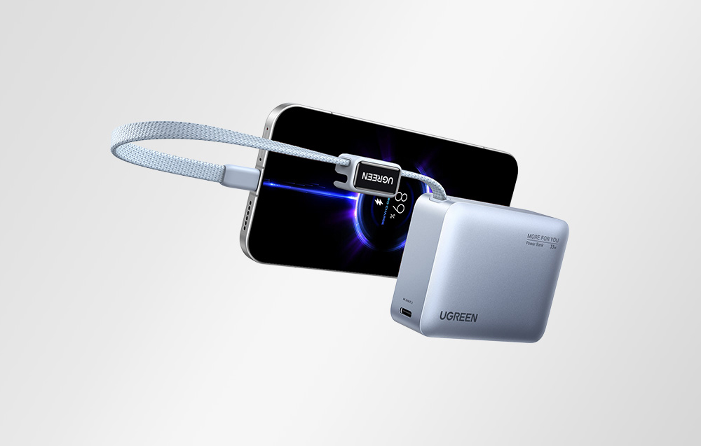 Szary powerbank Ugreen podłączony wbudowanym kablem do smartfona