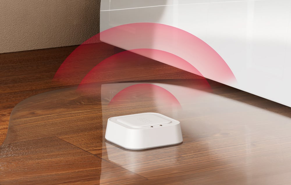 Intelligent water leak sensor MEROSS on wooden floor