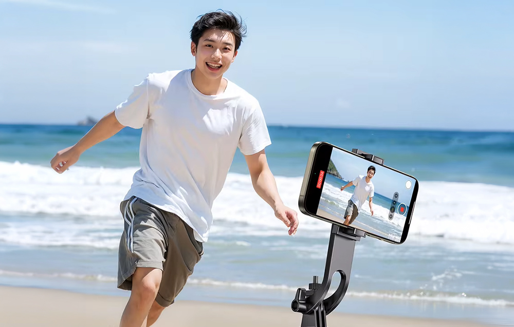 Man running on the beach, recorded with a smartphone mounted on a gimbal