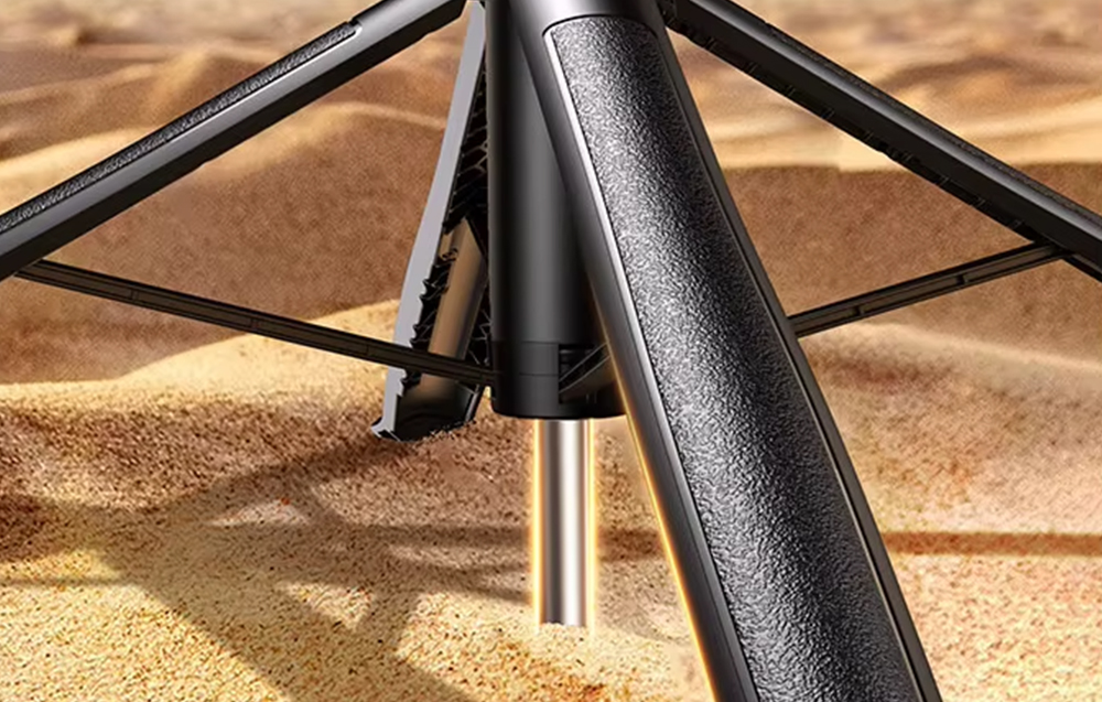 Close-up of the bottom of the deployed tripod with an additional stabilizing support stuck in the sand