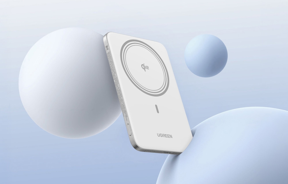 White Ugreen power bank on a blue background with blue balls