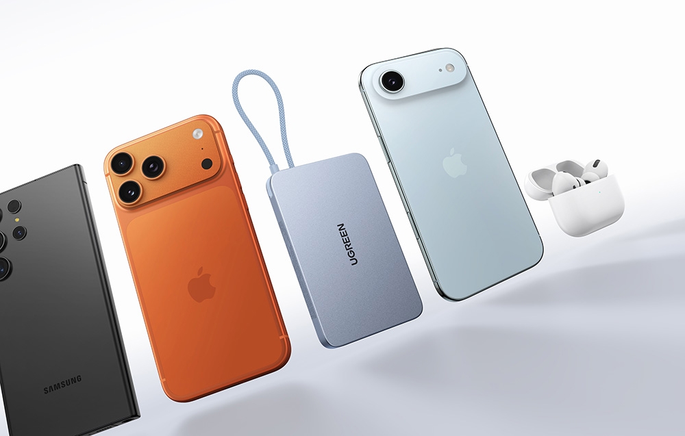 Smartphones in various colors, blue Ugreen power bank, and white TWS headphones arranged next to each other on a light background