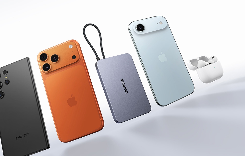 Smartphones in various colors, powerbank, and headphones on a light background