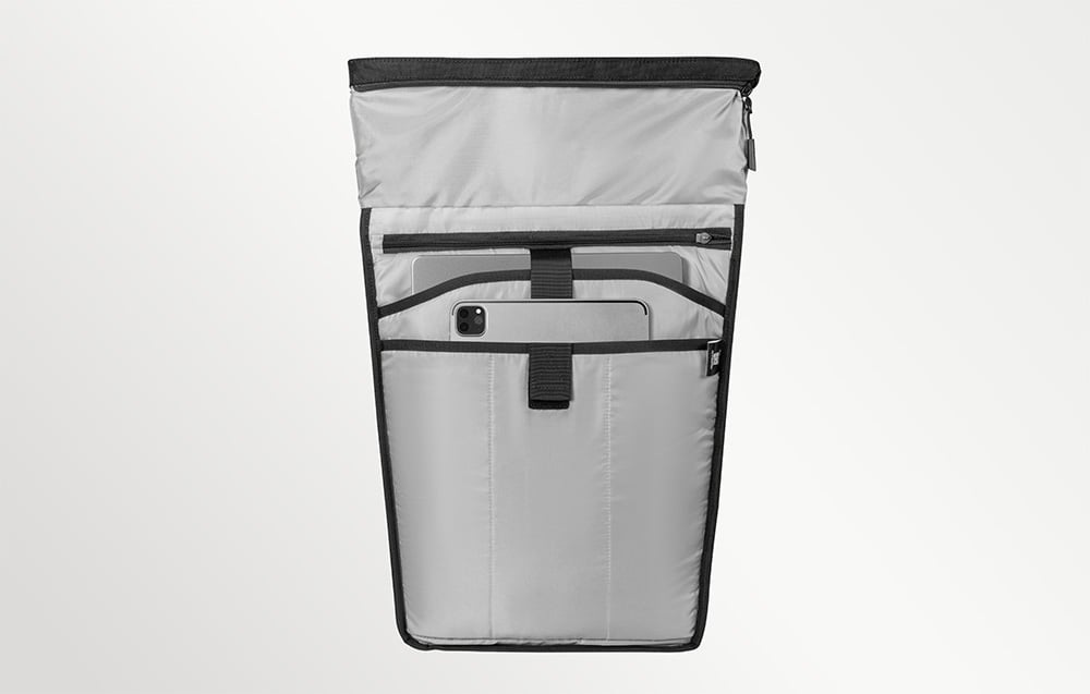 Jasnoszare wnętrze plecaka z przegrodami, w których umieszczono duży laptop oraz mniejszy tablet.