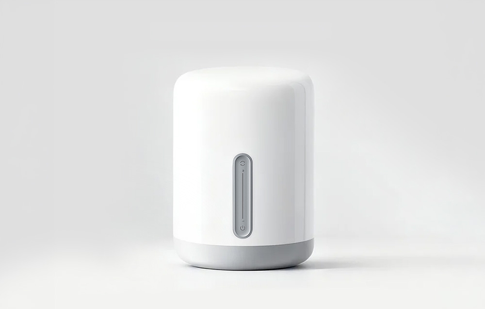Smart night light in white color, turned off, presented on a light studio background