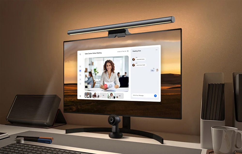 Desk monitor with Yeelight lighting and webcam, showing an online meeting on the screen