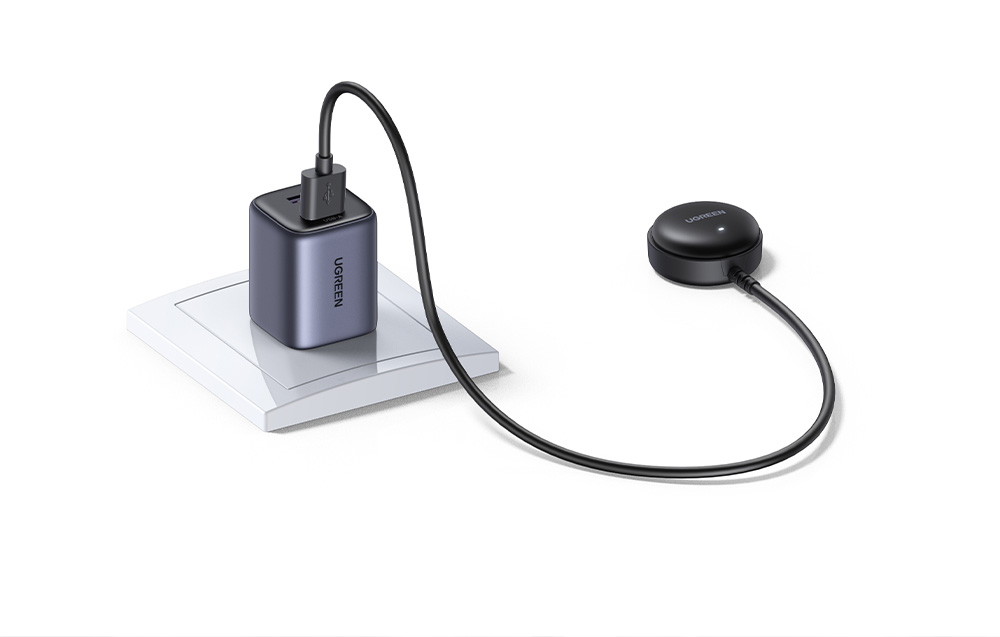 Black Ugreen wall charger charging via USB cable connected to the locator