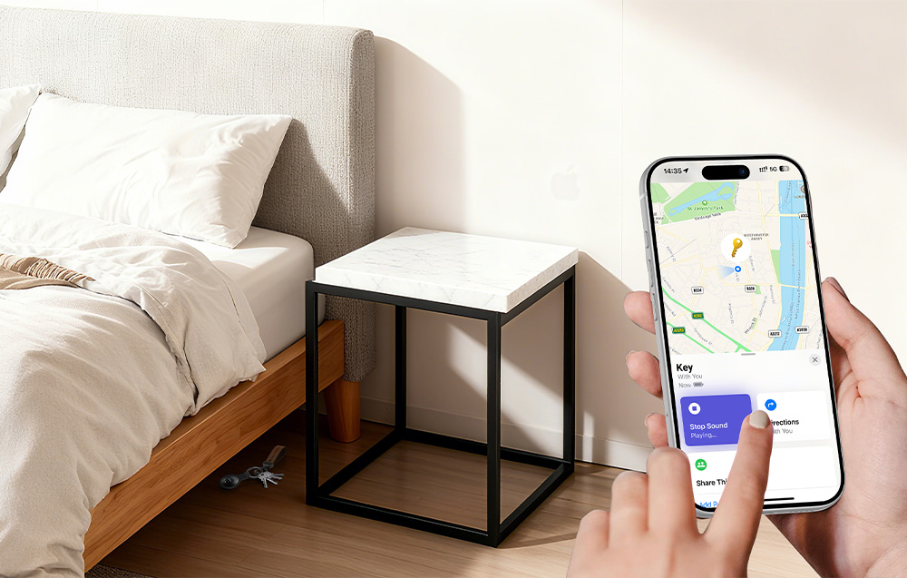Person holding a phone with an app to locate keys lying under a bed