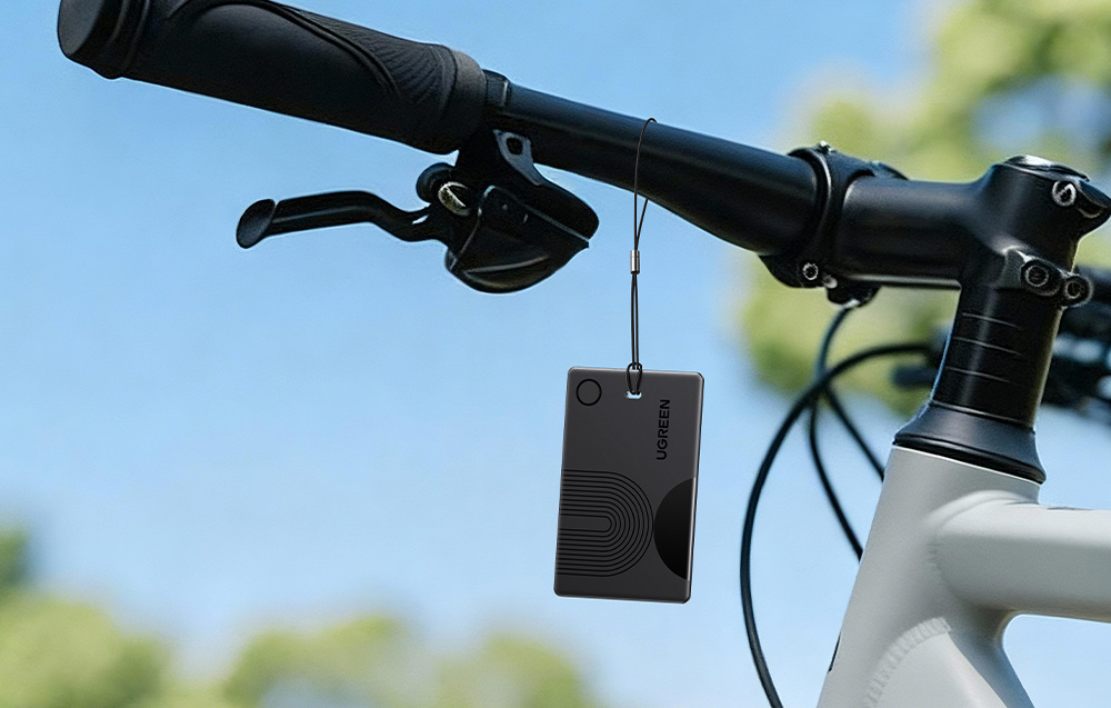 Black Ugreen card locator hanging from a bicycle handlebar