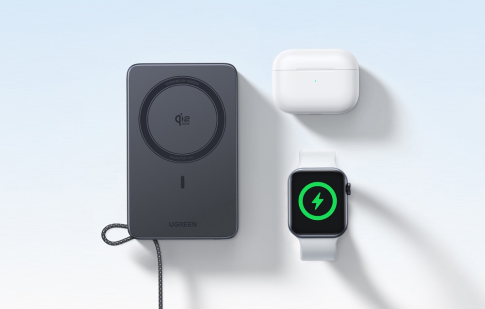 Ugreen Qi2 wireless power bank lying next to AirPods and Apple Watch