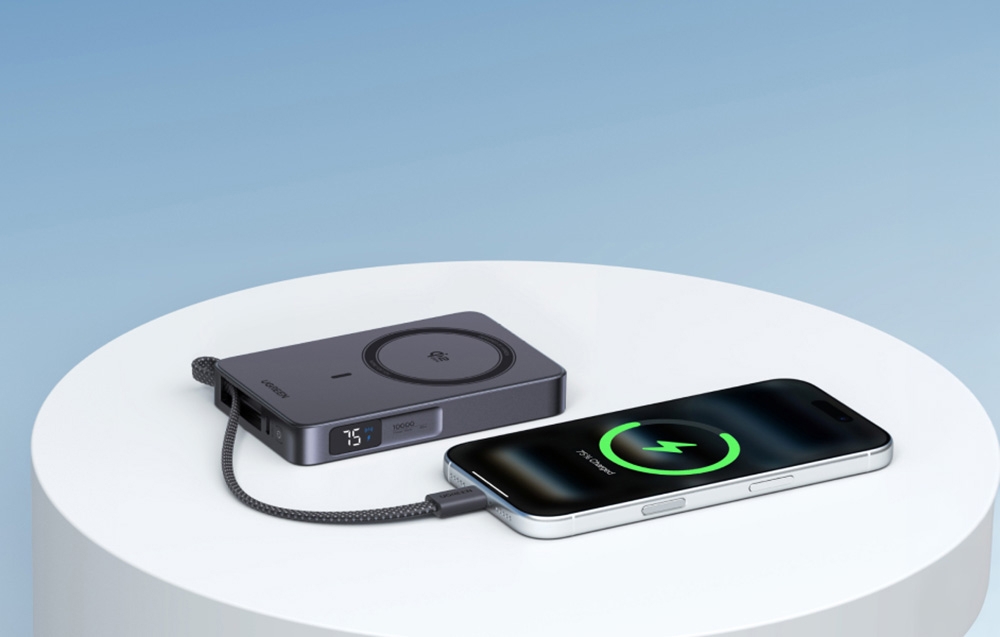 Gray Ugreen power bank with digital display charging iPhone smartphone using built-in USB-C cable