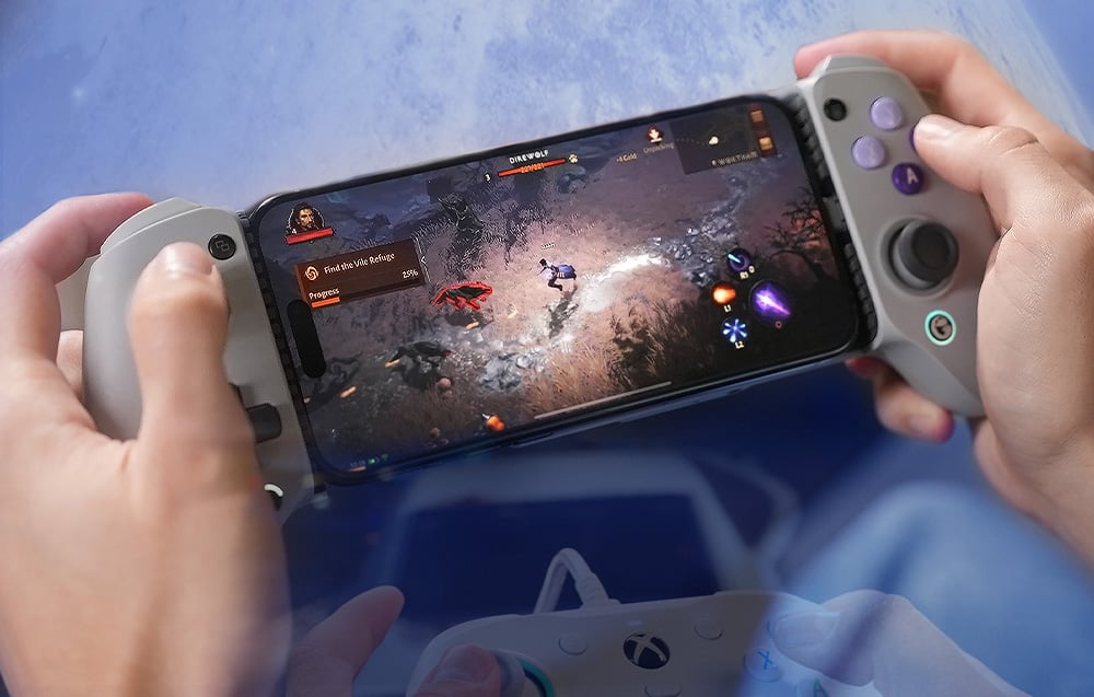 A controller held in hand with a smartphone connected, displaying a game